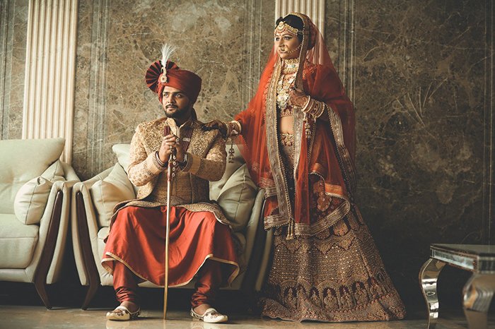 Beautiful wedding portrait of an Indian couple posing in traditional costume