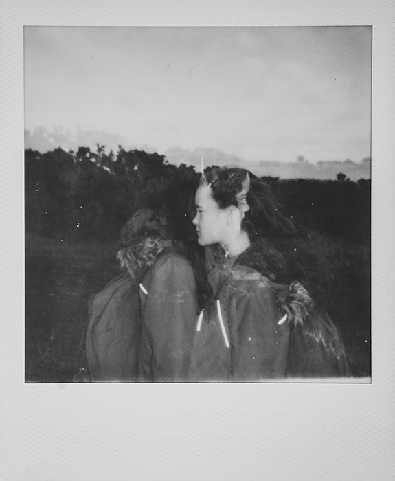 Monotone instant photography portrait of a young girl outdoors using multiple exposure technique