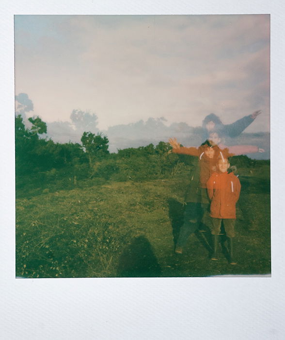 Dreamy instant photography portrait of a young boy outdoors using a multiple exposure technique