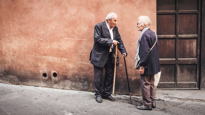 Street portrait of an elderly couple chatting - photography themes
