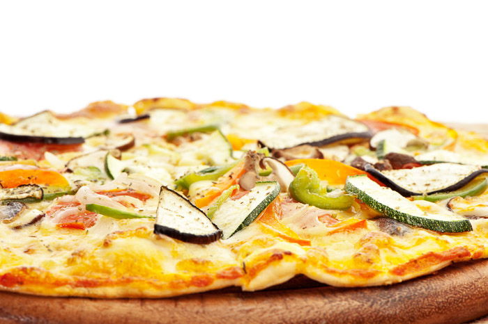 Close up of a fresh made vegetarian pizza shot with one softbox directly behind the subject. 