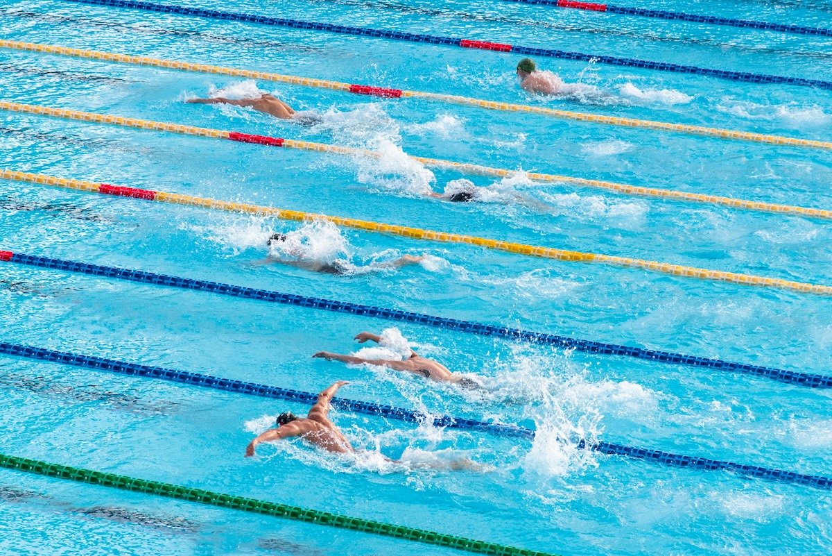 High-angle shot of swimmers racing as an example of swimming photography