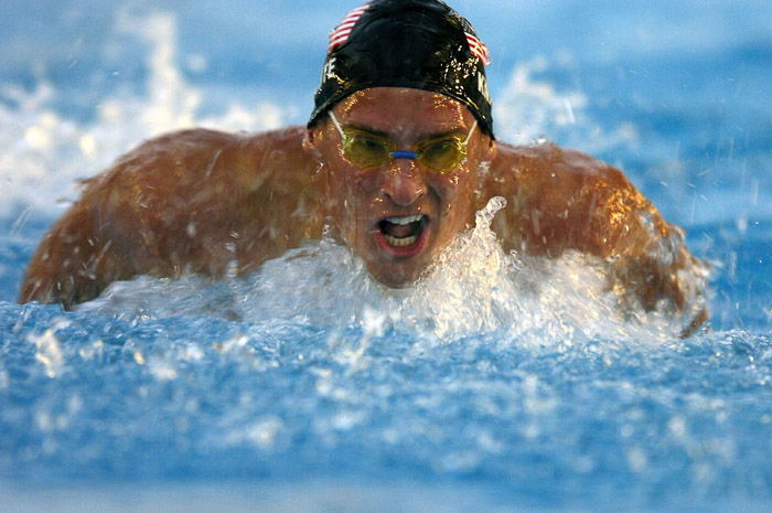 a face on view of a male swimmer in action