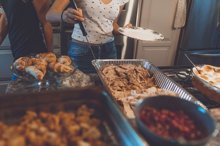 Candid thanksgiving picture of people serving themselves food