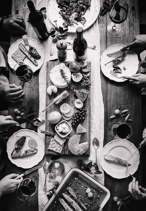 A black and white food photography flatlay of thanksgiving dishes on a wooden table