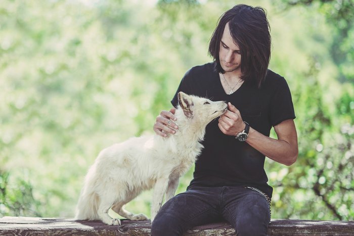 Sweet outdoor portrait of a man with a white dog - aperture for pet photography