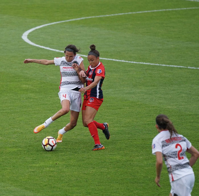 A soccer photography shot of female players mid-match