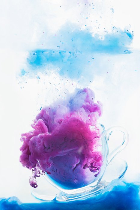a teacup filled with clouds of color - colorful paint in water photography