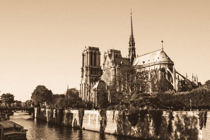 A vintage sepia tone image of the Notre Dame Cathedral in Paris