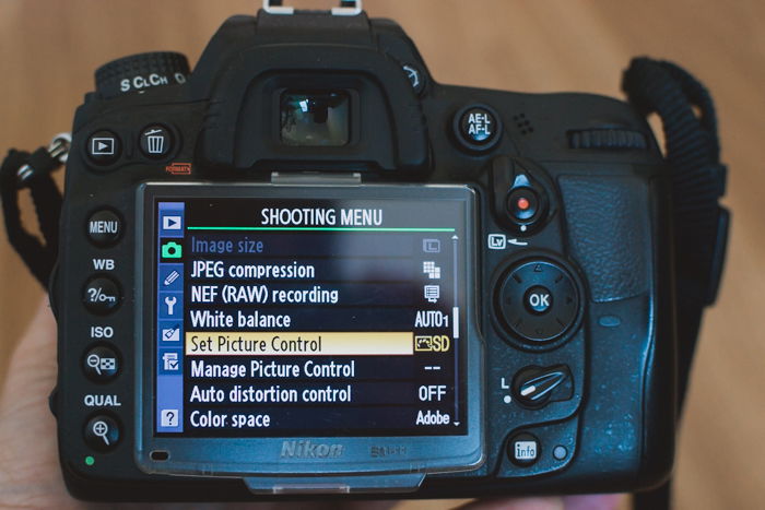 the settings on a Nikon DSLR showing how to shoot in sepia tone