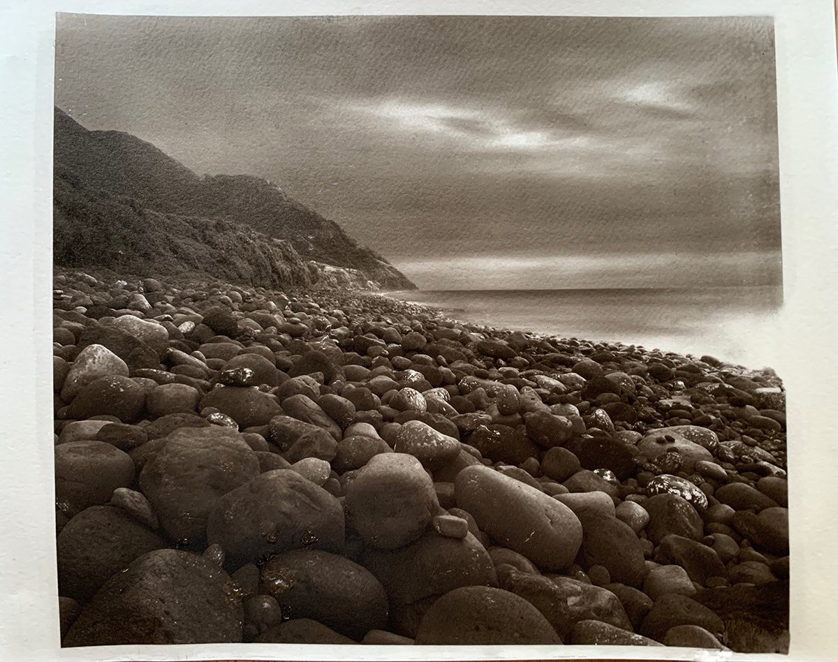 Alternative photography carbon print of a monochromatic seaside landscape