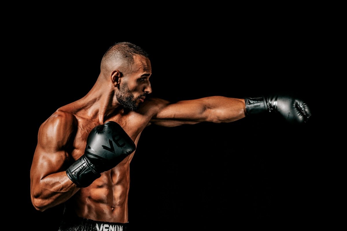 Side profile portrait of.a boxer making a punch as an example of boxing photography