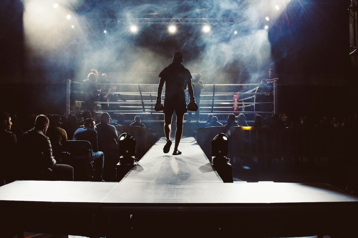 A wide-angle shot of a boxer walking to a ring as an example of boxing photography