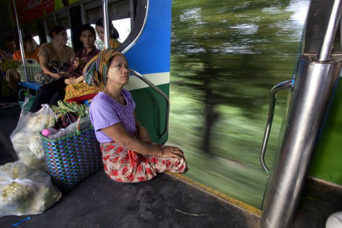 A woman sitting on a moving train - wide vs narrow aperture