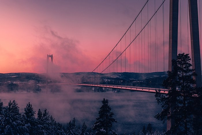 Artistic shot of a bridge in the colored light of sunset
