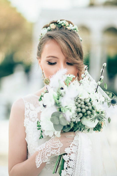 atmospheric close up wedding portrait of a bridesmaid holding a bouquet 