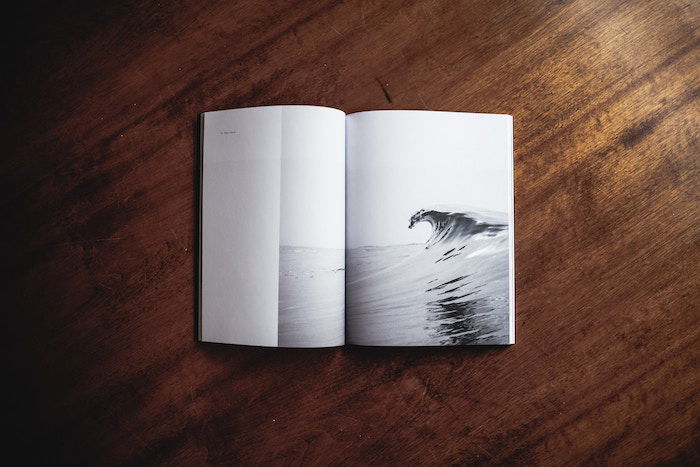 A minimalist photo book opened on a wooden table