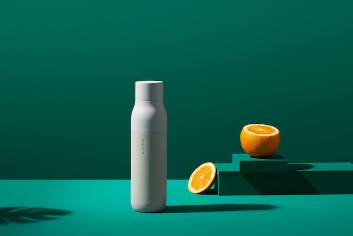 minimal product shot on green background - best lens for product photography