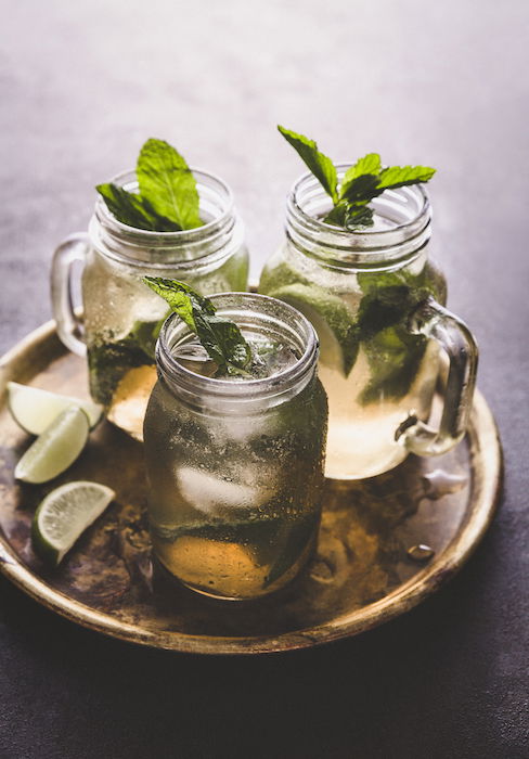 Stylish drink photo of three mojito cocktails on a tray