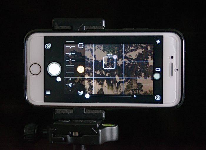 a smartphone set up on tripod to shoot landscape photos 