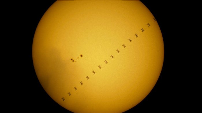 The ISS transiting in front of the Sun, passing next to a group of sunspots
