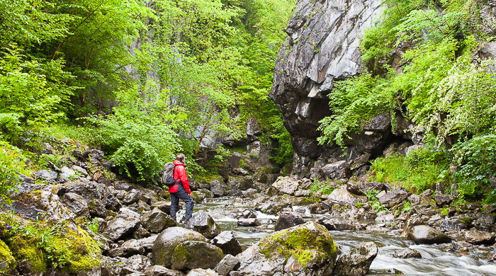 a hiker admiring a waterfall - adventure photography skills