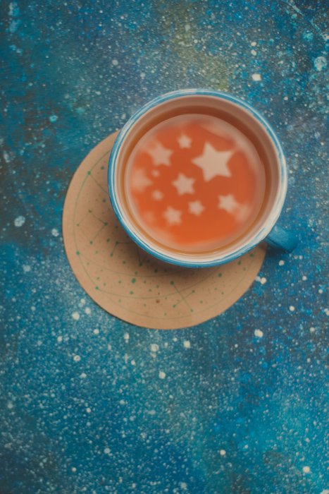 a creative still life featuring star shaped reflections in a coffee cup