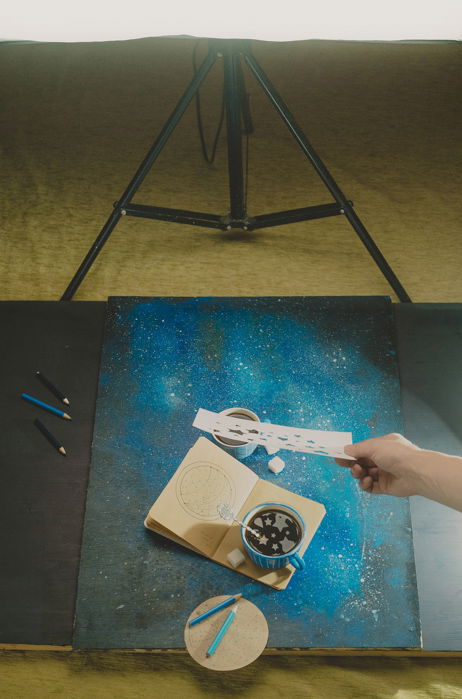 a creative still life setup featuring star shaped reflections in a coffee cup