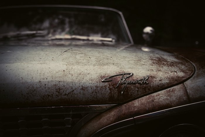 the front of a rusty plymouth car 