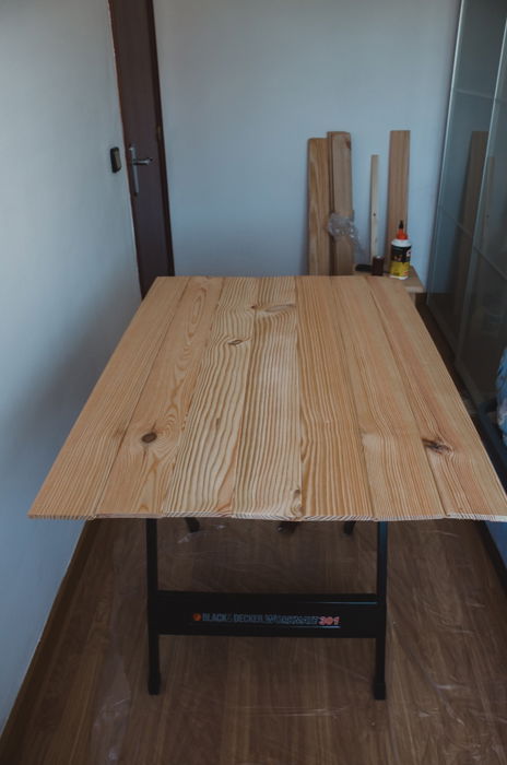 a person making a DIY wood backdrop for photography