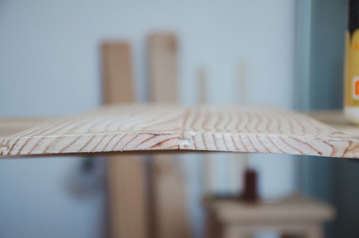 a person making a DIY wood backdrop for photography