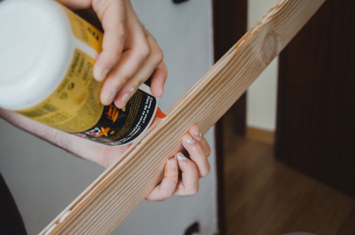 Wood-backdrop-injecting-glue-into-grooves