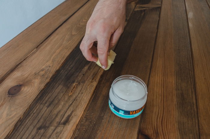 a person making a DIY wood backdrop for photography