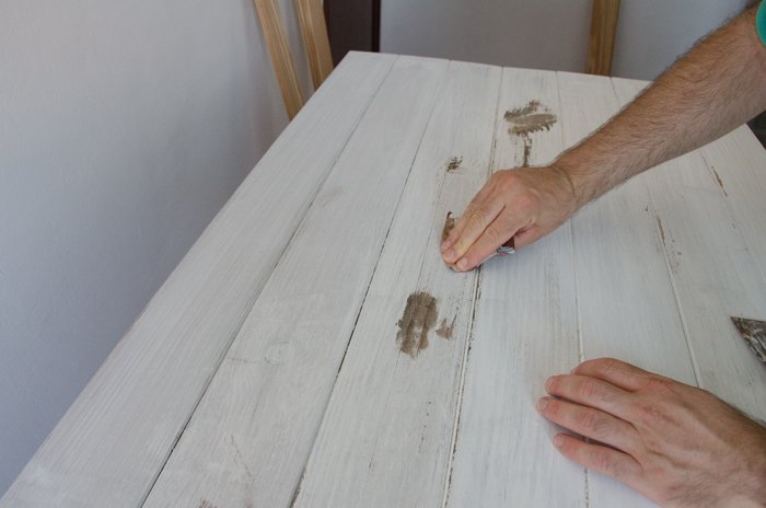 a person making a DIY wood backdrop for photography