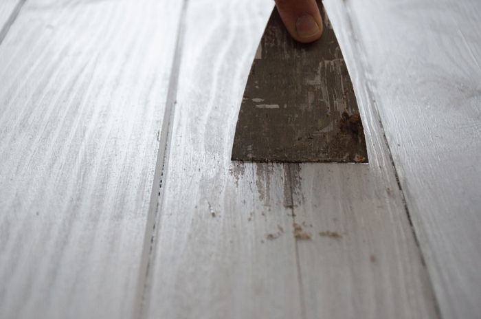 a person making a DIY wood backdrop for photography