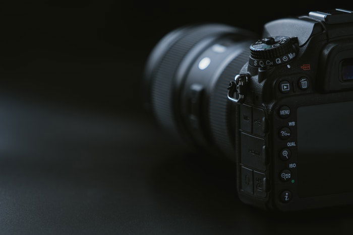 A DSLR on a dark background 