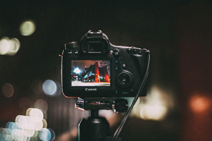 camera on a tripod at nighttime