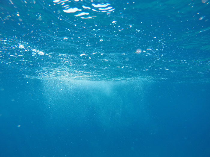 an underwater shot of rippling water - symbolism in photography