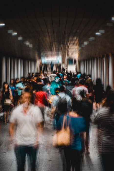 blurry street photo of a group of people walking through a subway station - focus breathing