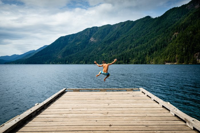 cool portrait of a man jumping from a wooden pier - focus breathing tips 