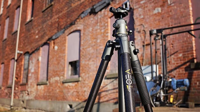 A Vanguard VEO 2 tripod setup outside a brick building