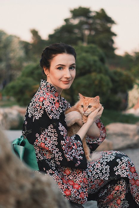 a minimalist portrait of a female model holding a cat