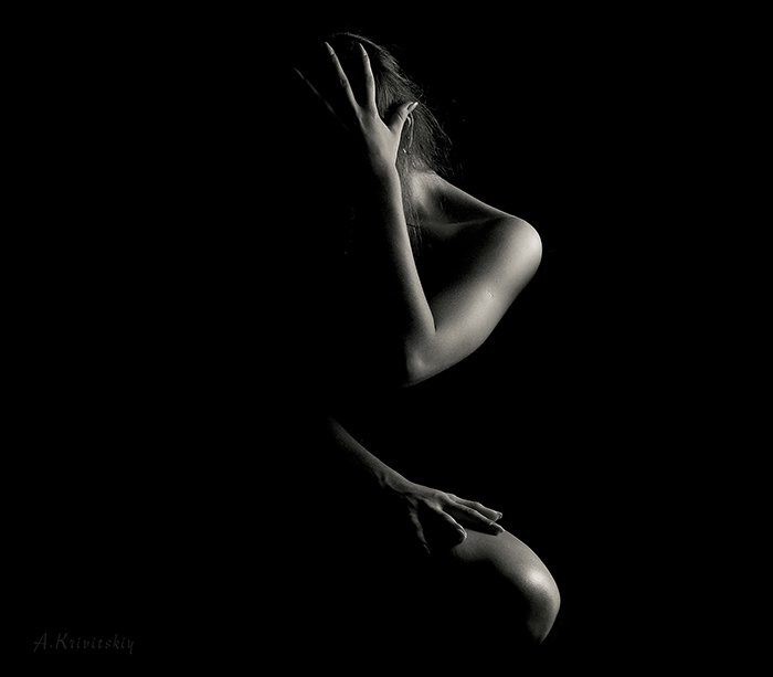 Artistic low key nude photography of a female model 