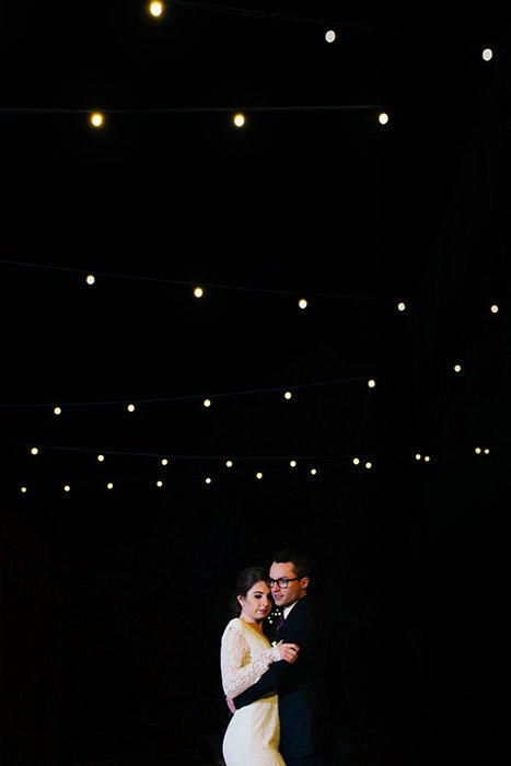portrait of the newlyweds dancing at an outdoor wedding at night