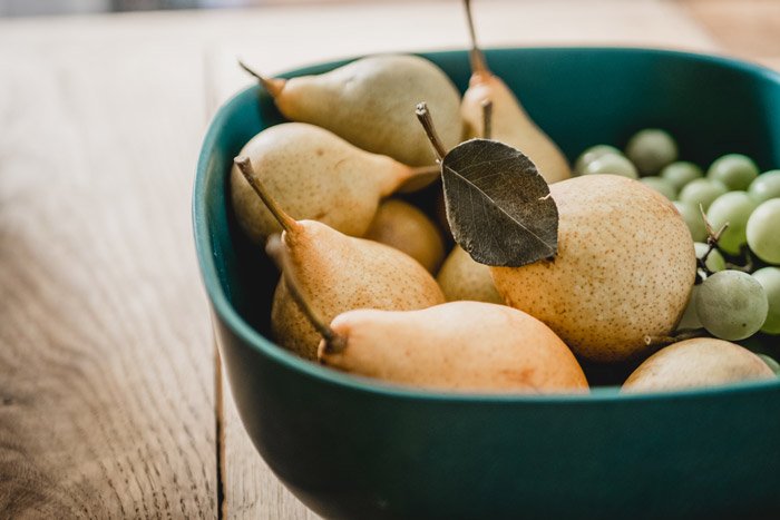 a bowl of pears and grapes - symbolism in photography