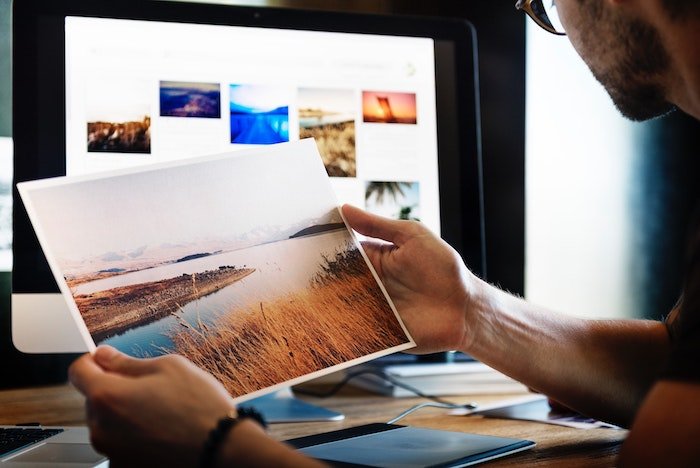 a photographer editing landscape images in a home office 