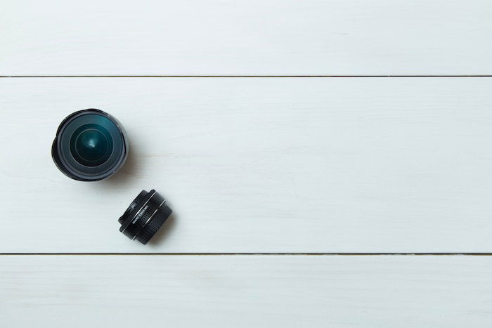 overhead shot of two prime lenses on white boards