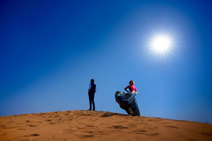 a stunning portrait of a couple posing in a desert shot with the Profoto b10 flash