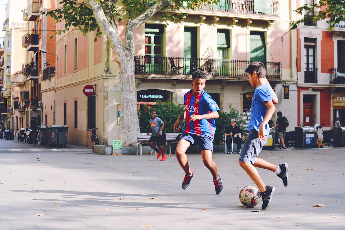 Two kids playing in street as an example of soccer photography