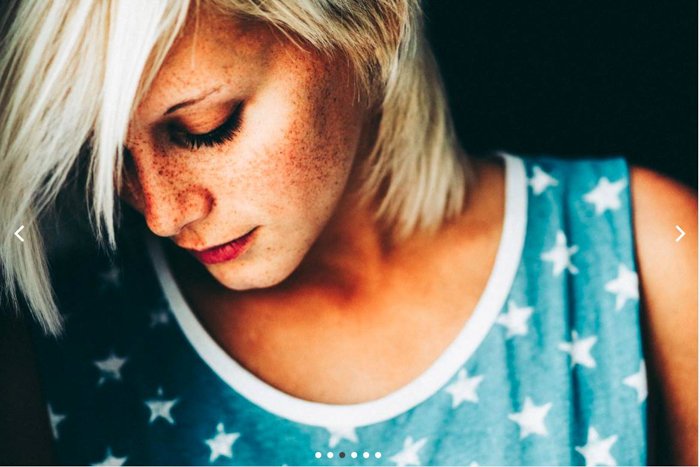 Close-up portrait of a woman with freckles in a star-patterned vest luc besson preset